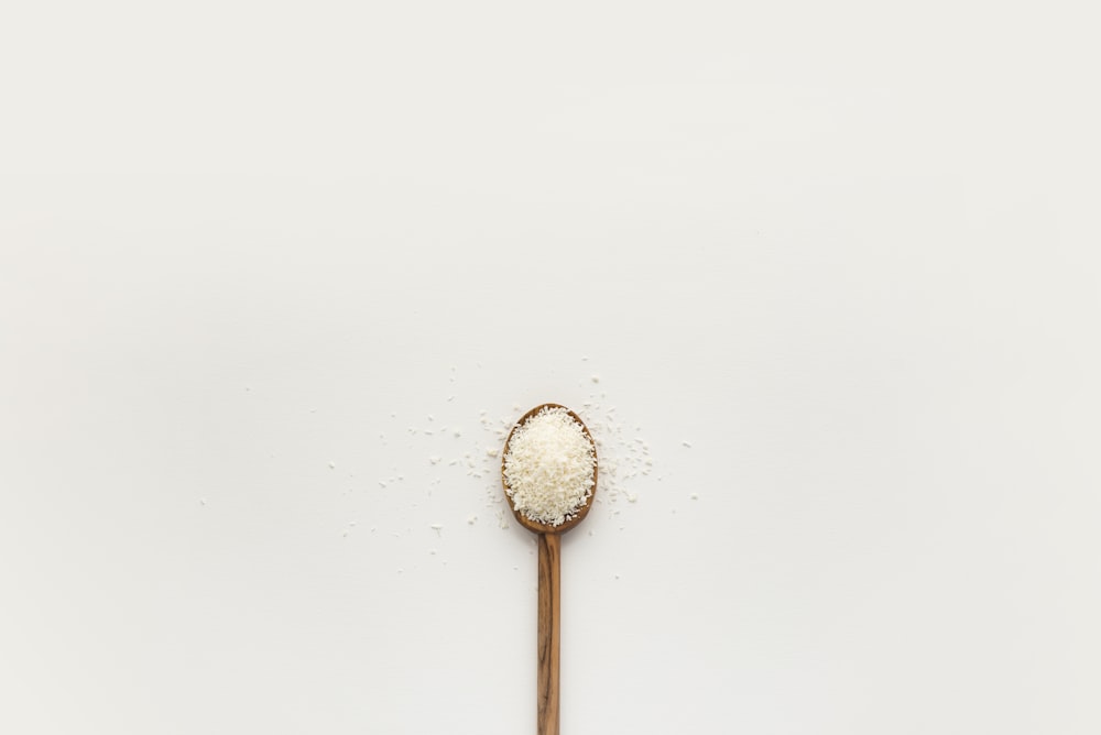 white powder on brown wooden spoon