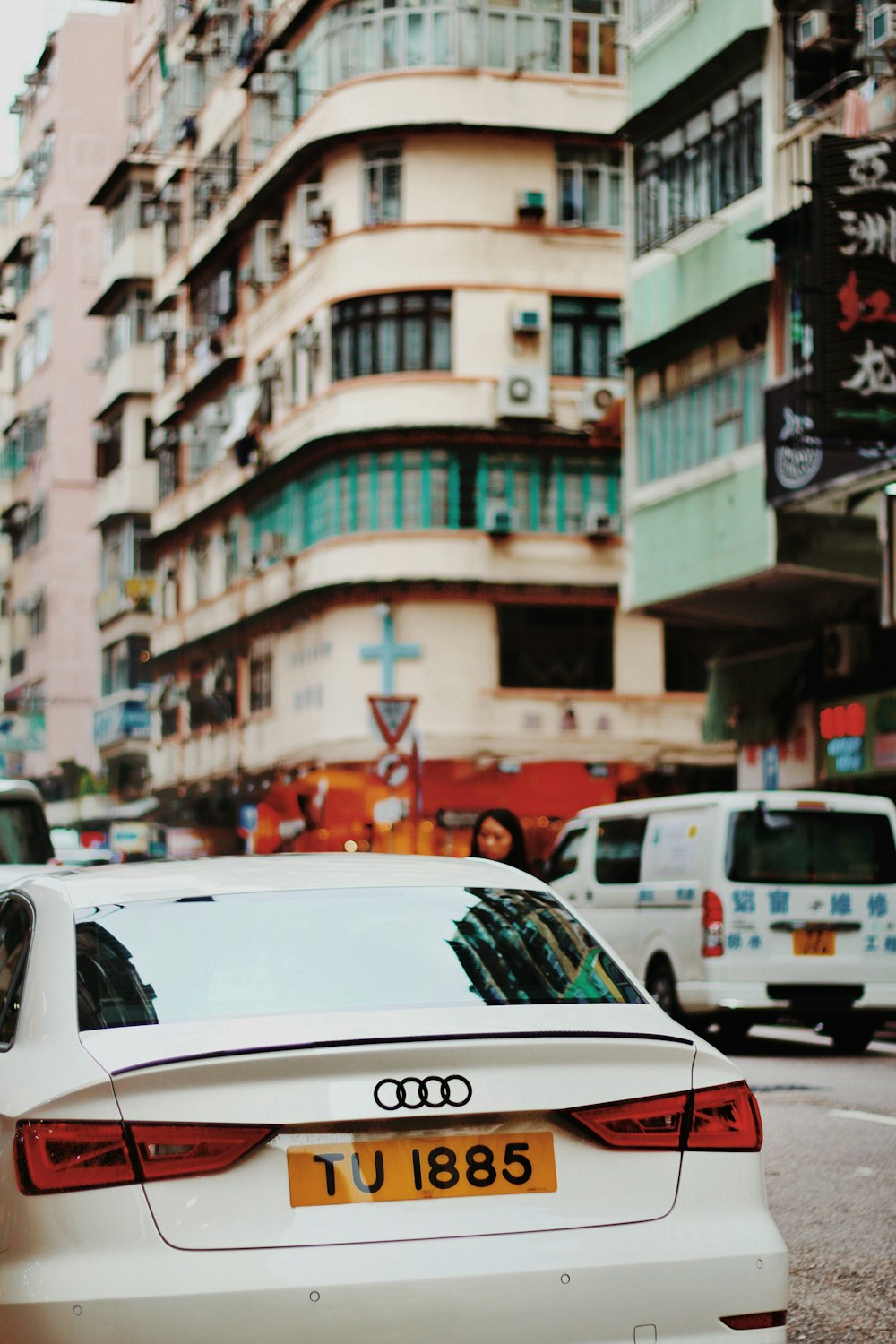 white Audi vehicle on gray concrete road during daytime