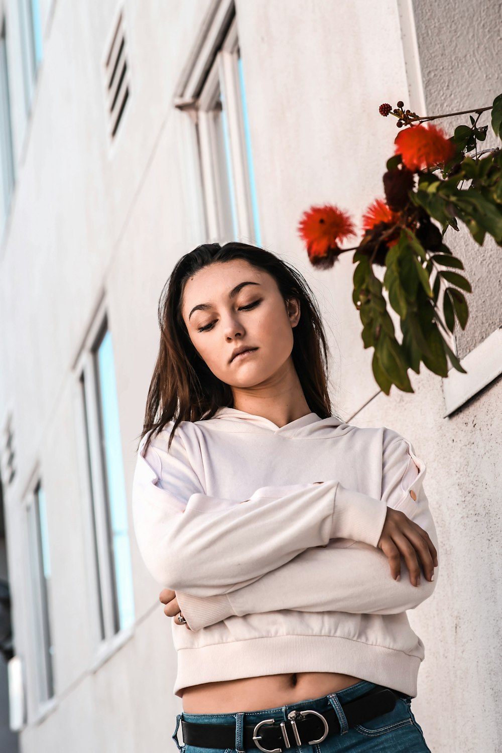 woman standing near gray concrete building during daytime