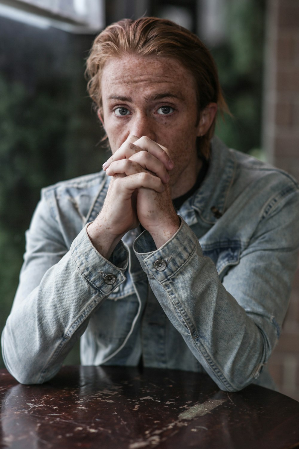 man in gray-washed denim jacket