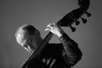 Black and white image of a street musician immersed in his craft.