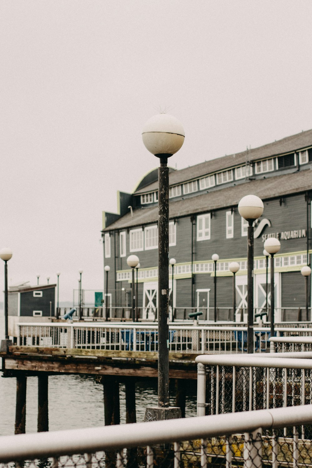 a couple of street lights sitting next to a body of water