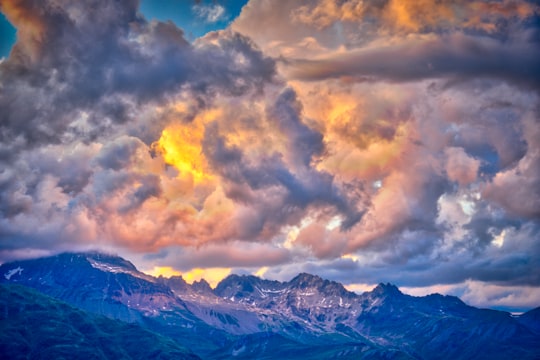 photo of mountain range under golden sky in Muottas Muragl Switzerland