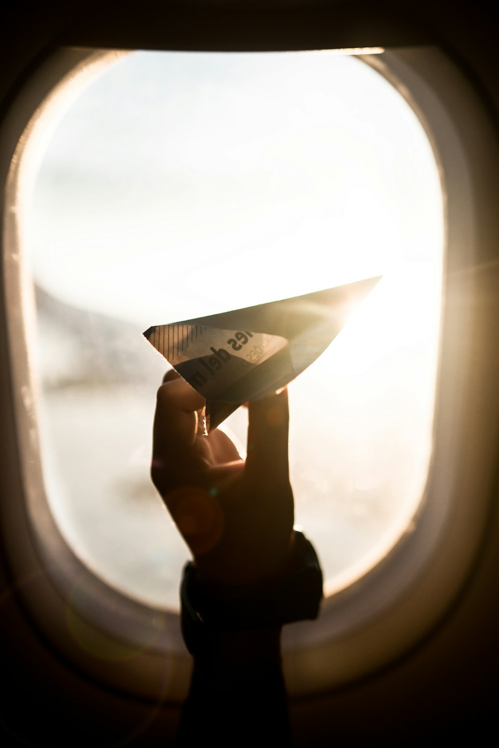 person holding paper plane