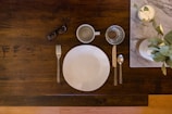 white ceramic plate on brown wooden table