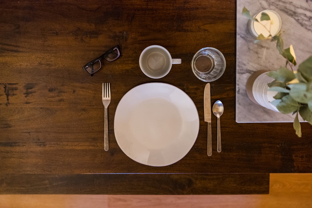 white ceramic plate on brown wooden table,