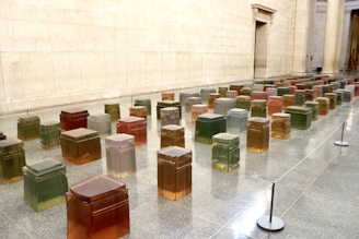 Modular block installation in a gallery space with dark hues and sharp grid lines evoking identity layers