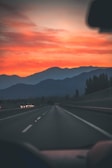 A beautiful sunset view from a transfer vehicle on a mountain road.