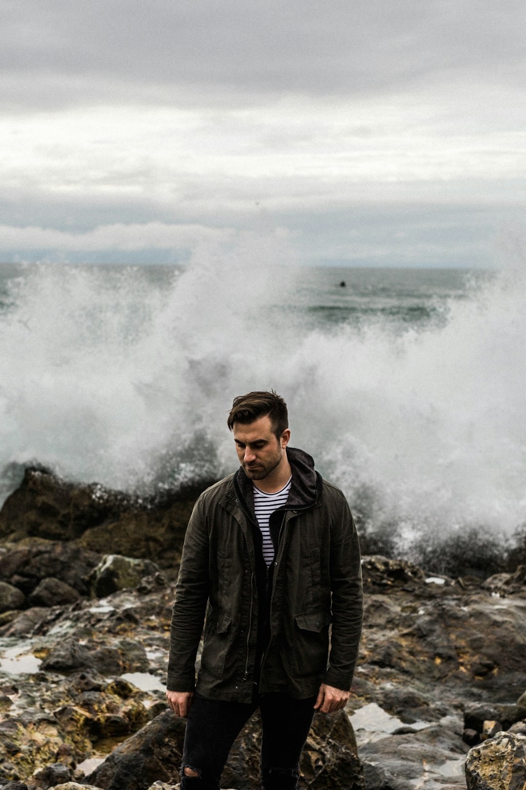 man standing near rocky hill