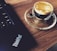 A person reading a product review on a laptop with a cup of coffee nearby.