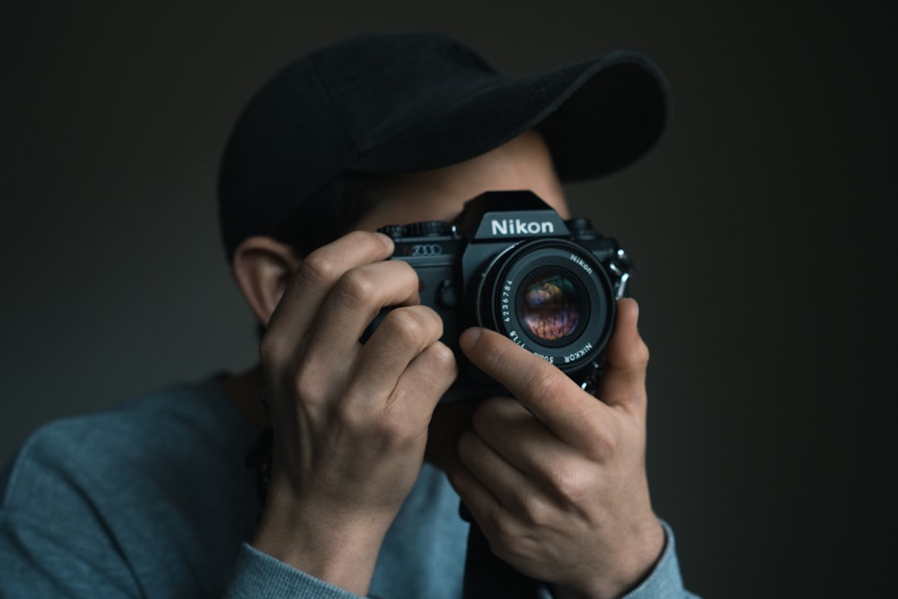 person using Nikon DSLR camera