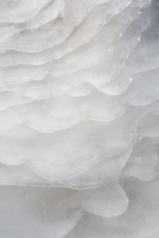 Abstract layered paper textures with soft shadows and subtle collage elements reflecting clarity and structure.