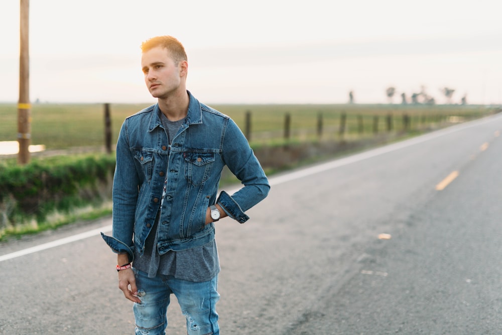 rule of thirds photography of man standing in the middle of road