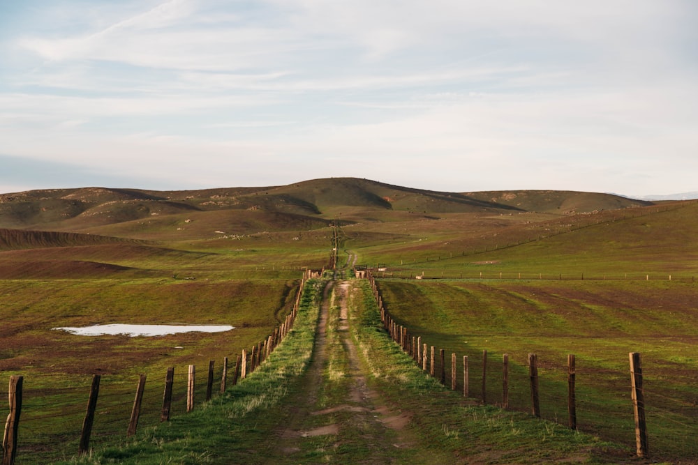 road with mountain view under white clouds during daytime