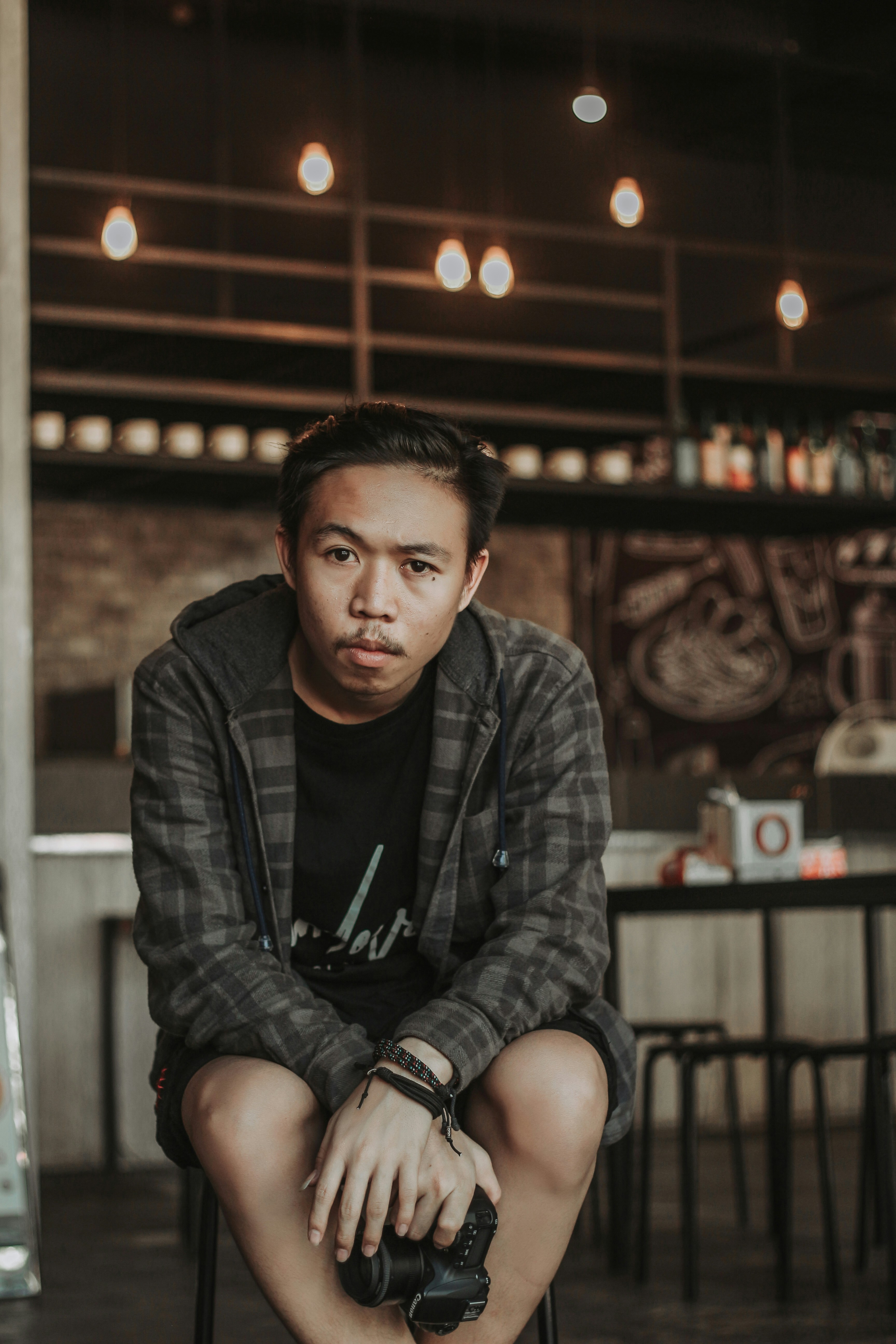man holding black Canon DSLR camera