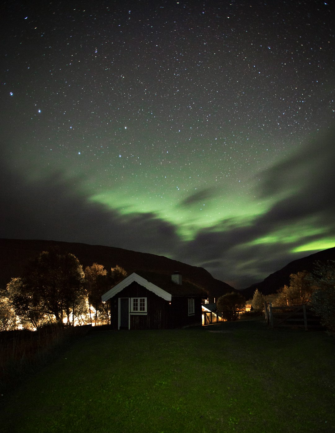 shed under green aurora sky