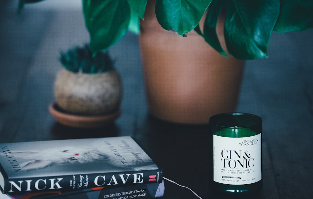 Nick Cave book beside Gun & Tonic tealight on black wooden table
