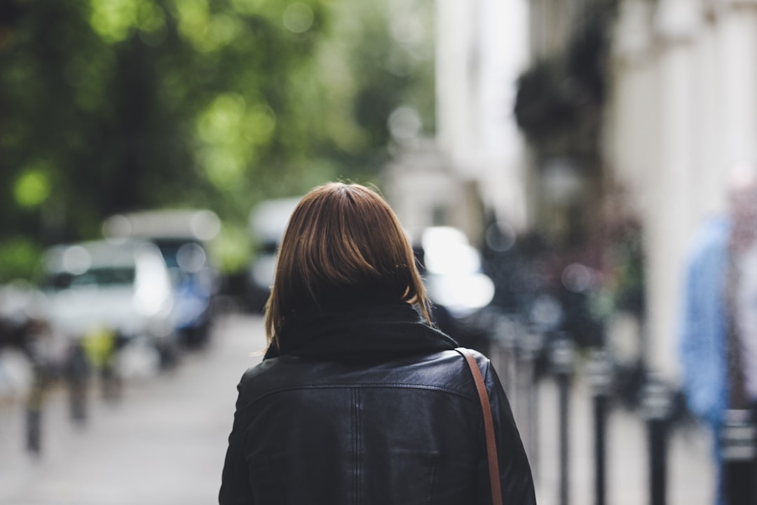 woman wearing black leather jacket shallow photography