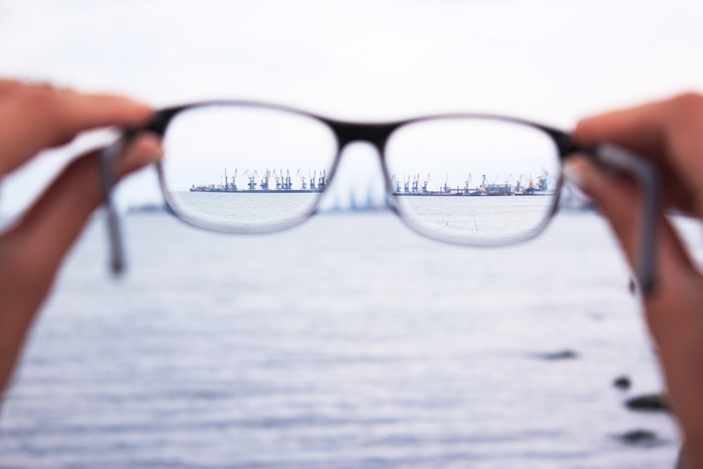 person holding eyeglasses