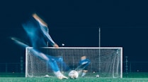 timelapse photo of soccer player kicking ball