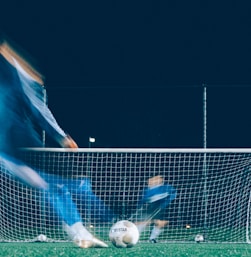 timelapse photo of soccer player kicking ball