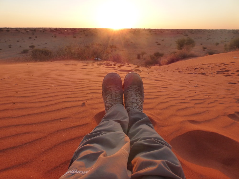 person sitting on sand