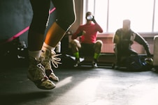person wearing brown-and-white shoes jumping