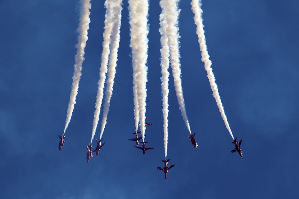 low angle photography of plane contrail