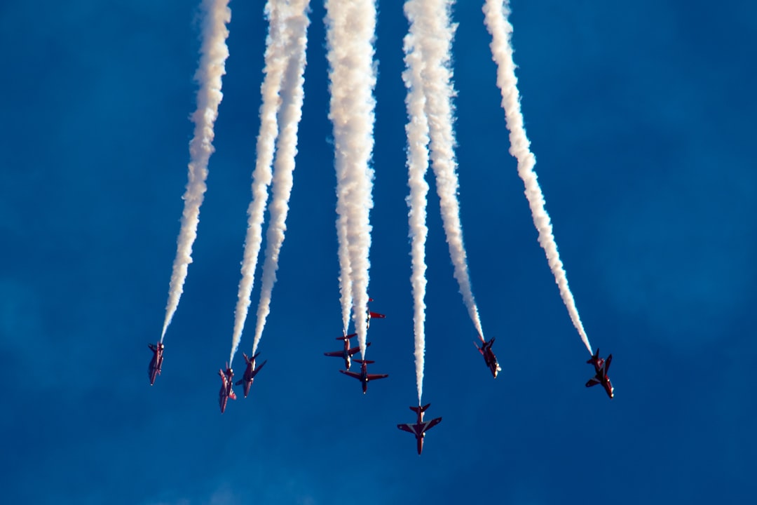 low angle photography of plane contrail