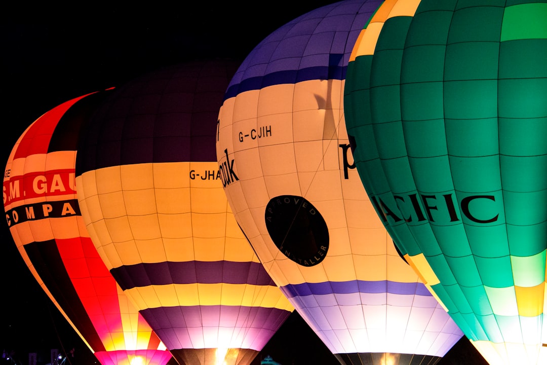 four yellow, red, and green hot air balloons