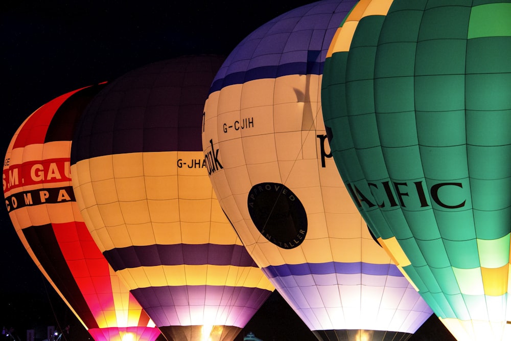 four yellow, red, and green hot air balloons