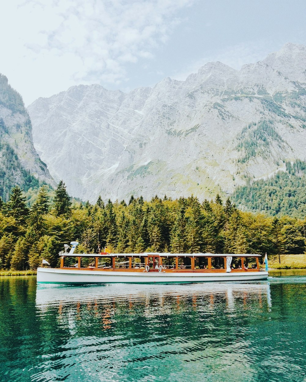 white and brown boat in body of water