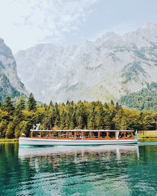 white and brown boat in body of water in Königssee Germany