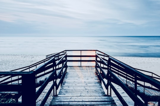 sea dock under cloudy sky in Dźwirzyno Poland