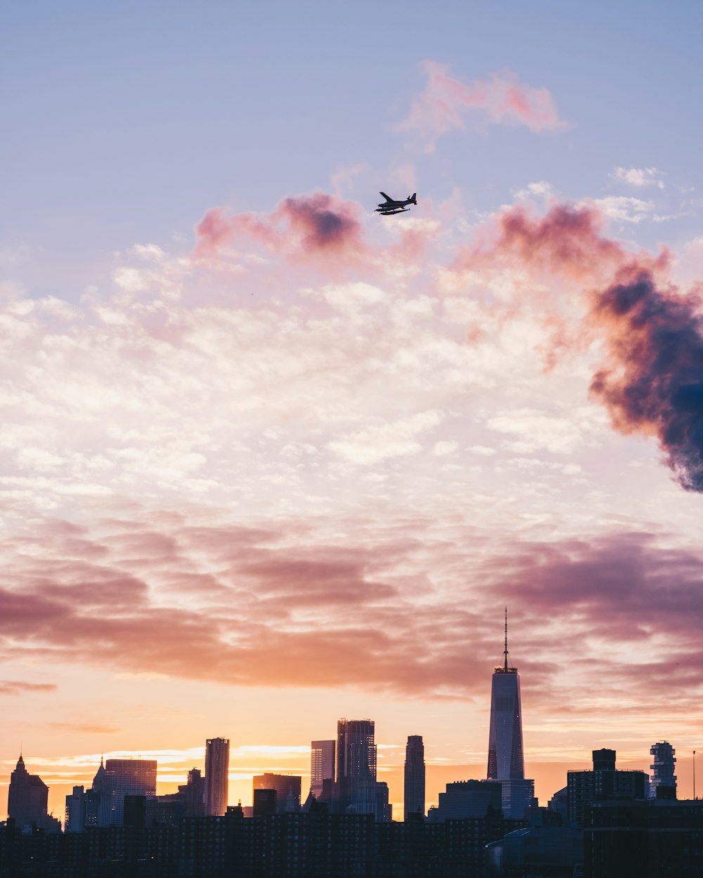 silhouette of plane flight over the city