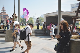 People enjoying a sunny day at a local festival.