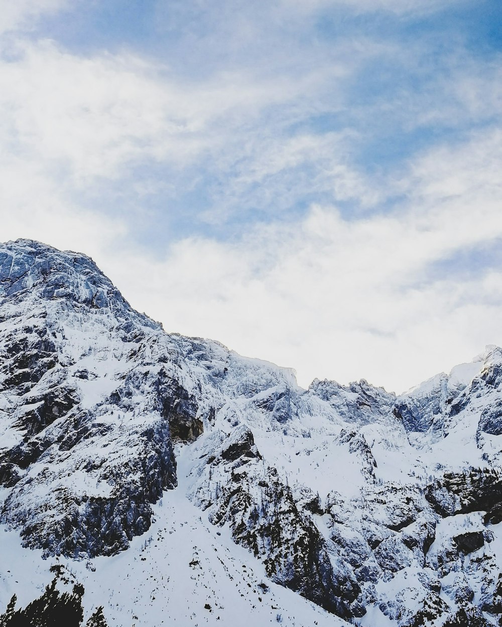 permafrost mountains under partially cloudy skies