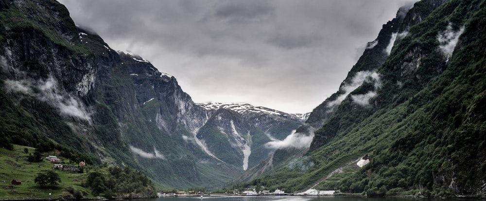 green and black mountain under the gray cloud at daytime