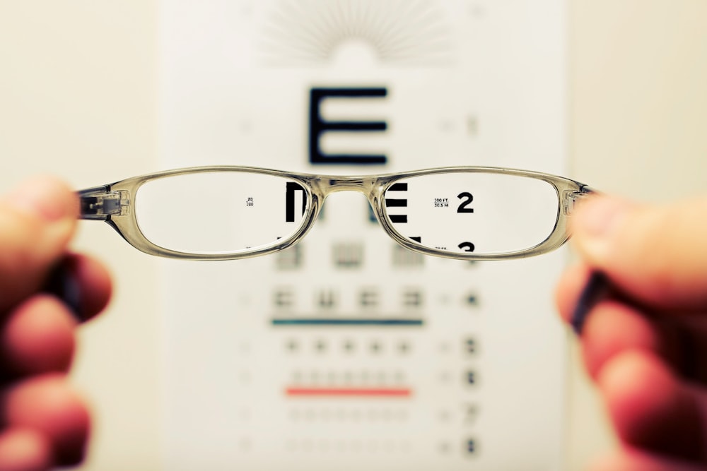 person holding eyeglasses