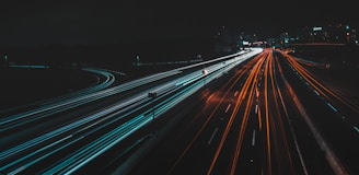 time lapse photography of lighted road at night