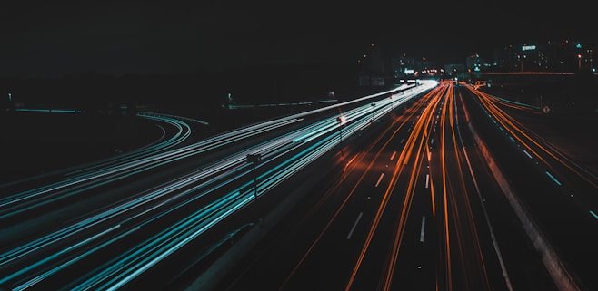 time lapse photography of lighted road at night