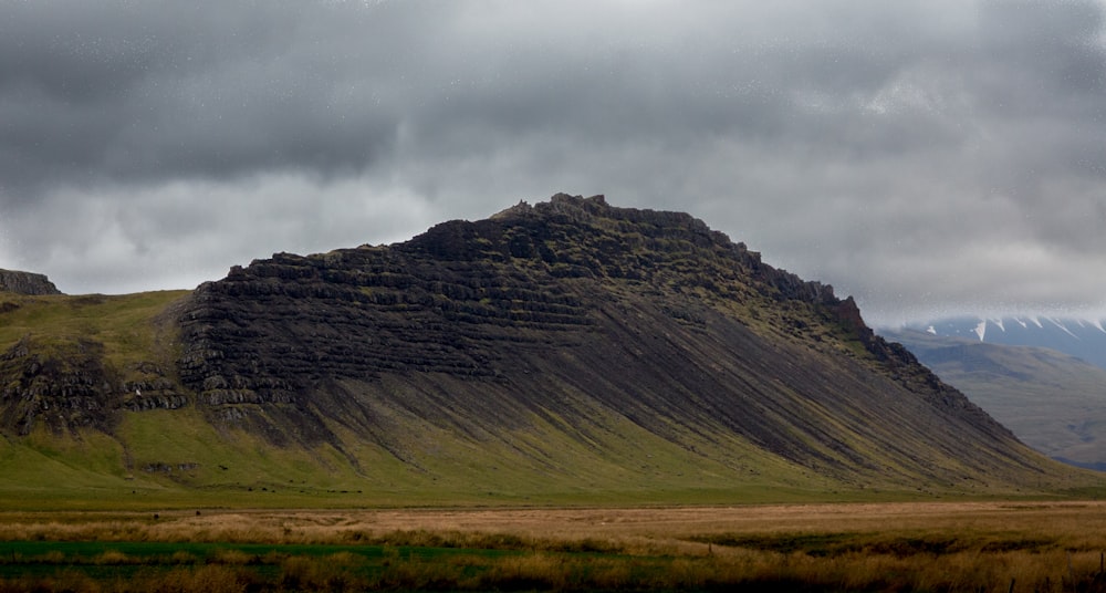 gray mountain under gray clouds