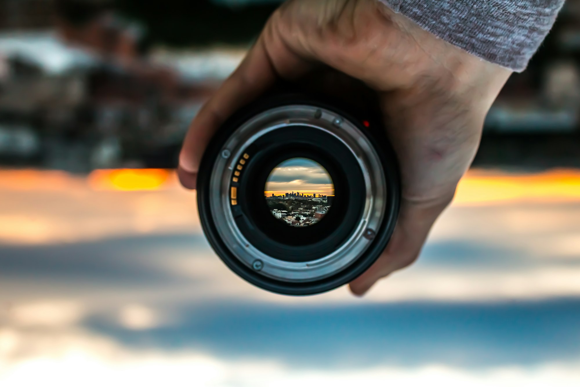 person holding black camera lens