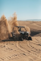 person riding an UTV on desert