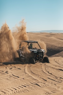 person riding an UTV on desert