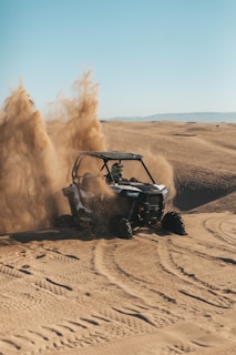 person riding an UTV on desert