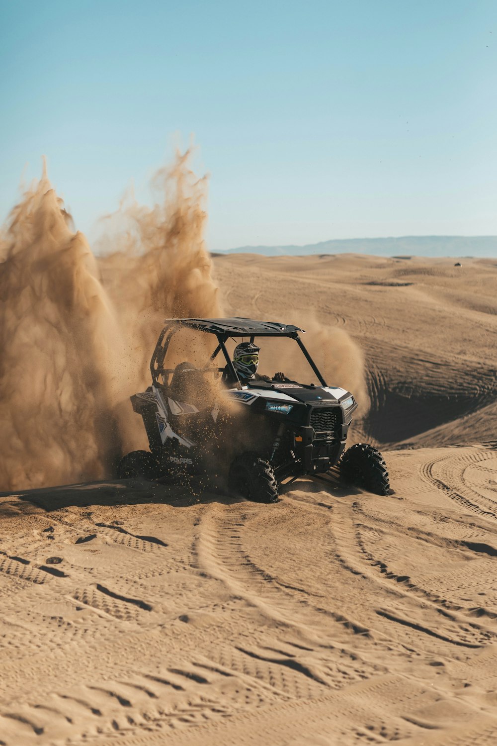 person riding an UTV on desert