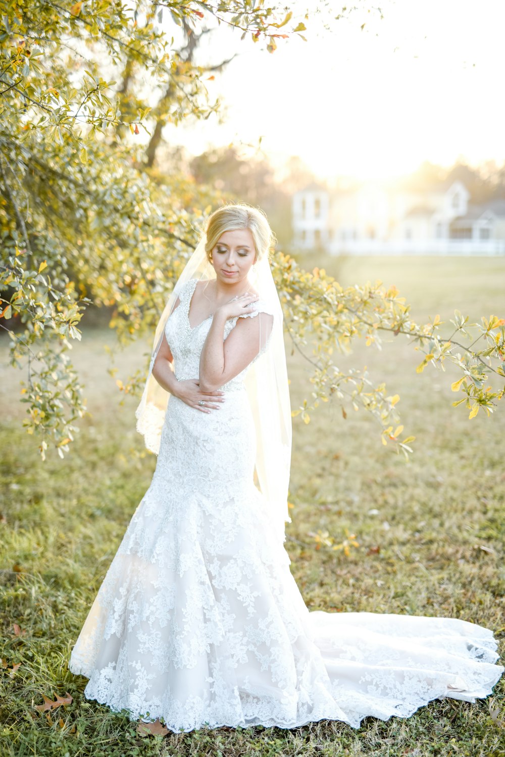woman wearing white wedding dress near green leaf tree outdoors
