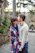 man kissing on woman forehead standing near tree during daytime