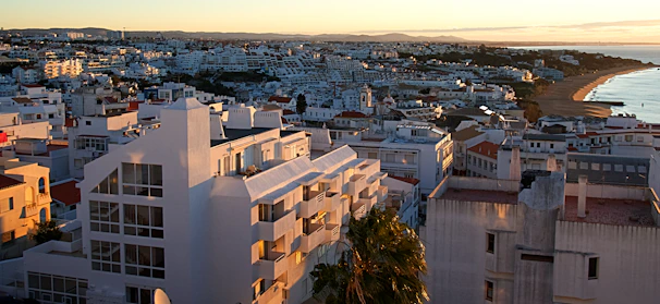 Sunset view of Touros cityscape highlighting the beach and colorful buildings.